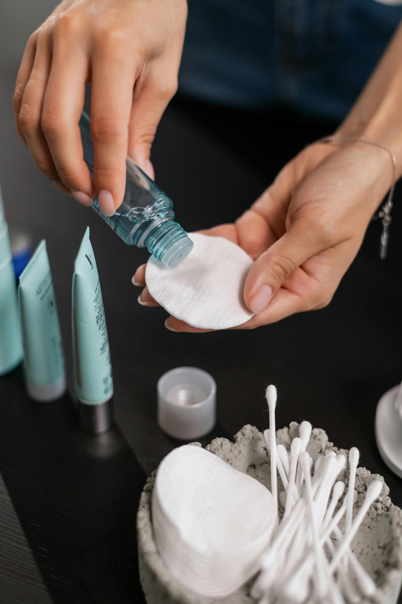 Applying toner to a cotton pad — skincare routine for dry climates and hydration.
