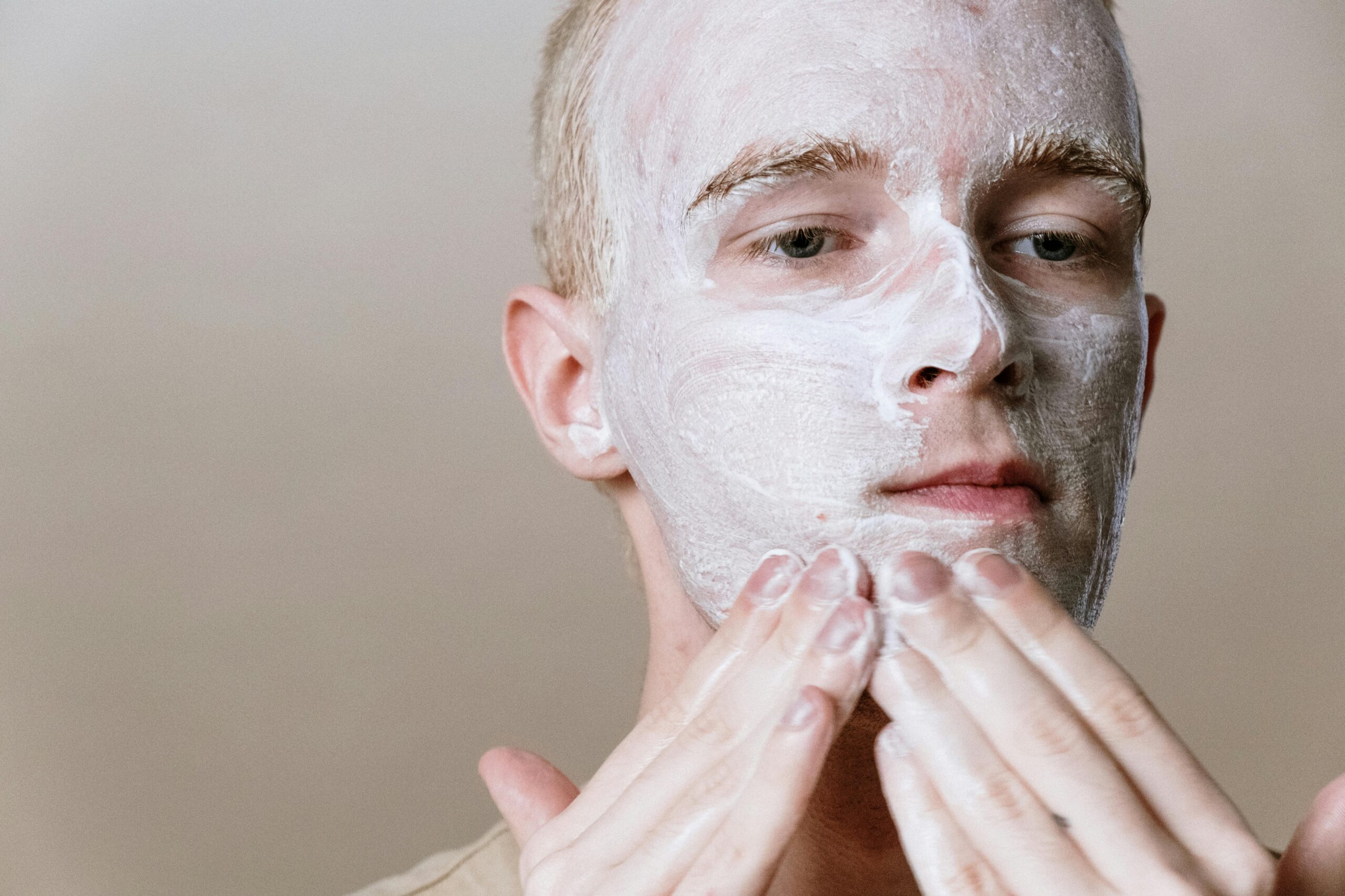 Person applying a white face mask to their skin during a skincare routine – featured image for why your skincare suddenly stops working