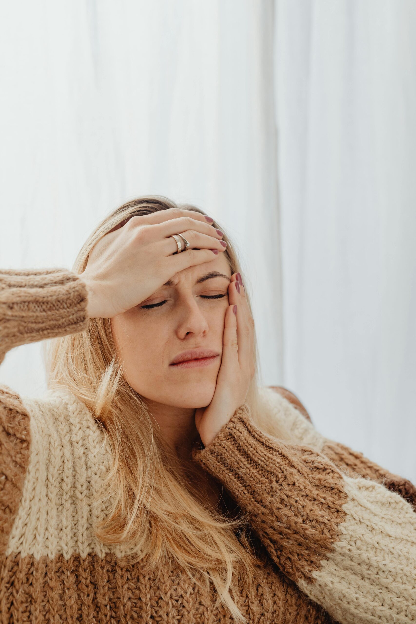 woman holding face showing irritation – why does my skincare sting on dry skin