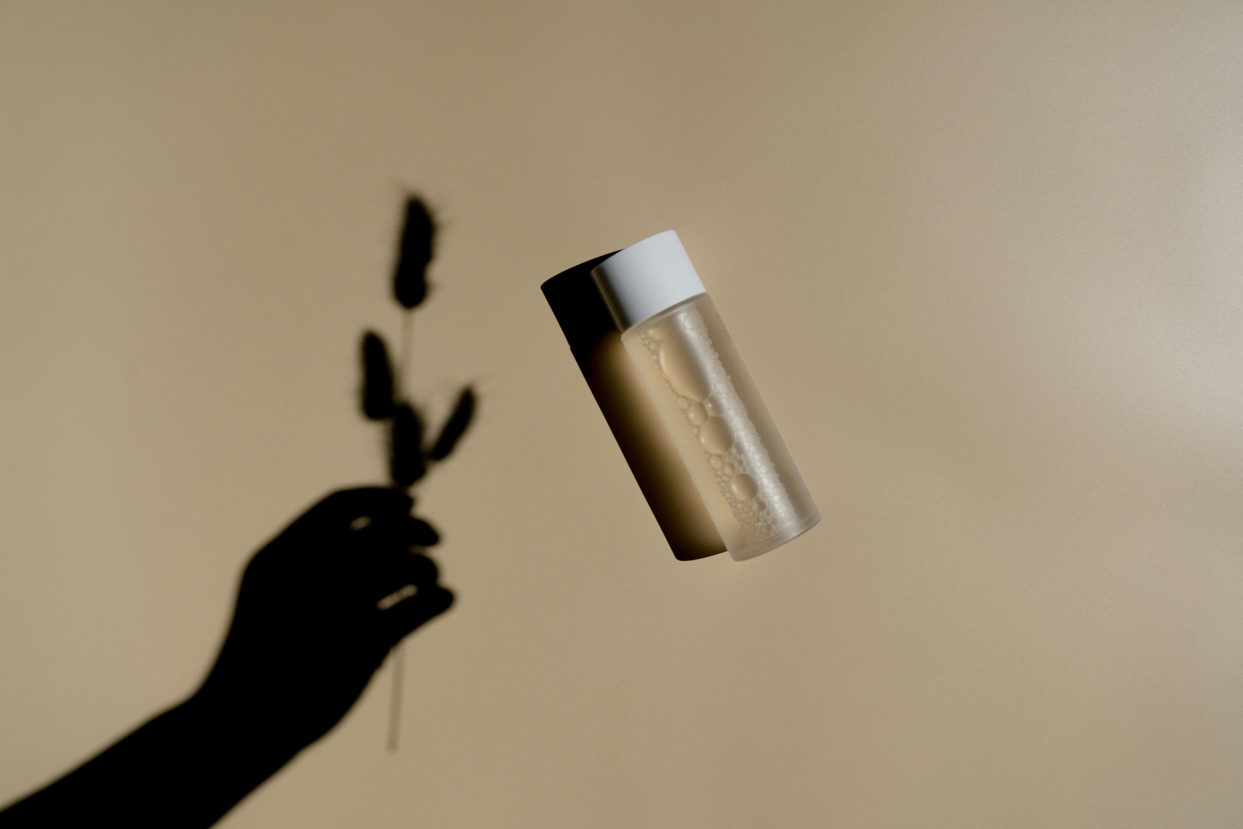 best hydrating toner for dry skin in low humidity – minimal skincare bottle on neutral beige background